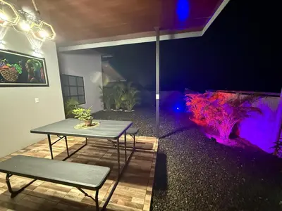 a table and bench in a room with a aquarium at Arenal Star Luxury Studios with Private Jacuzzi in Fortuna
