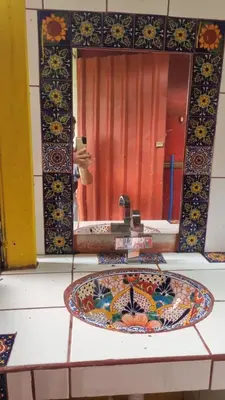a bathroom counter with a sink and a mirror at Cabaña las Palmeras Pura Vida!! in Linda Vista