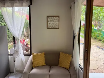 a living room with a couch and a window at Quiet, Affordable Casita Close to Surf & Nature - 15 minutes drive to Samara beach in Nandayure