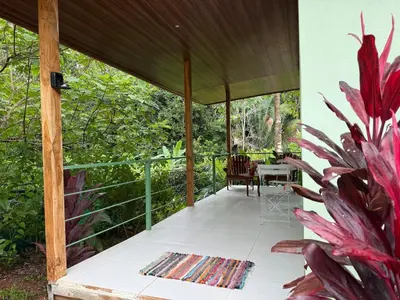 a porch with a table and a plant at Quiet, Affordable Casita Close to Surf & Nature - 15 minutes drive to Samara beach in Nandayure