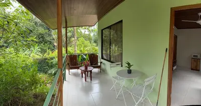 a balcony of a house with a table and chairs at Quiet, Affordable Casita Close to Surf & Nature - 15 minutes drive to Samara beach in Nandayure