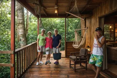 a group of people standing on a porch of a house at Jungle Overnight