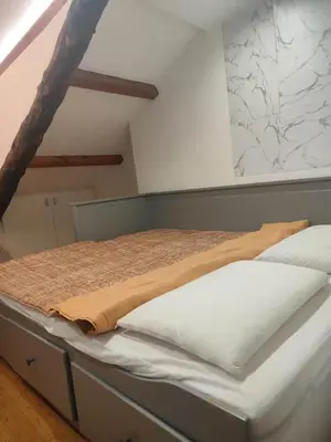 a bed with a blanket on it in a room at Cozy Central Apartment in San José
