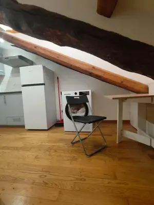 a room with a bed and a chair and a table at Cozy Central Apartment in San José