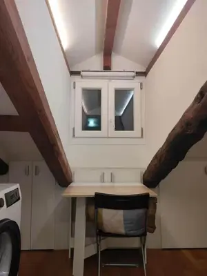 a small kitchen with a table and a window at Cozy Central Apartment in San José