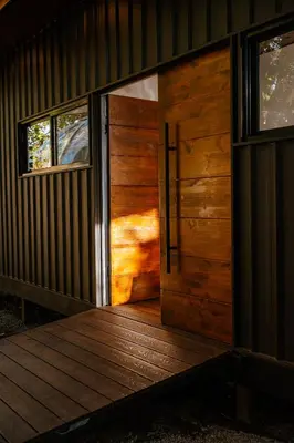 a wooden door of a house with a wooden deck at AMANI Casa Suite in San Rafael