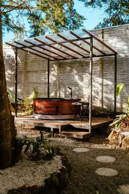 a wooden tub sitting under a pavilion in a yard at AMANI Casa Suite in San Rafael