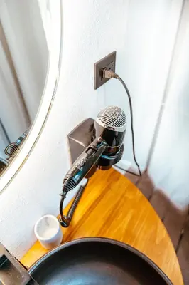 a hair dryer sitting on top of a bathroom sink at AMANI Casa Suite in San Rafael