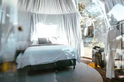 a bedroom with a bed with a white canopy at AMANI Casa Suite in San Rafael