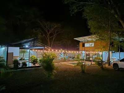 a house lit up at night with lights at Casa Pura Jungla in Santa Cruz