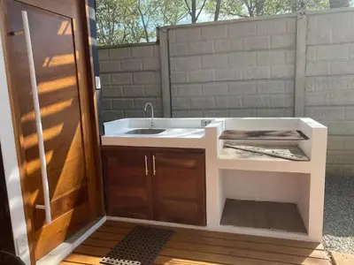 a bathroom with a white sink and a sink at Casa Pura Jungla in Santa Cruz