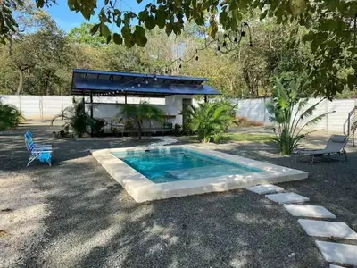 a swimming pool in a yard with a building at Casa Pura Jungla in Santa Cruz