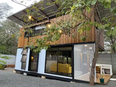 a building with a lot of windows and a tree at Casa Pura Jungla in Santa Cruz
