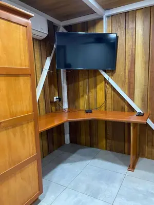 a room with a tv on a wooden wall at Casa Pura Jungla in Santa Cruz