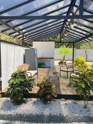 a patio with chairs and tables and potted plants at Casa Pura Jungla in Santa Cruz