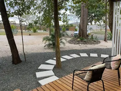 a wooden deck with a chair and a tree at Casa Pura Jungla in Santa Cruz