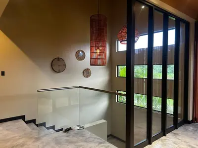 a room with a glass staircase and a large window at Villa Paraíso in Quepos