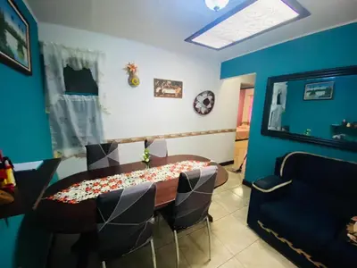 a room with a table and chairs and a blue wall at Hermosa House Tibas