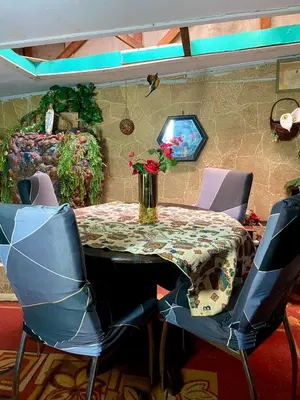 a table with chairs and a vase of flowers on it at Hermosa House Tibas