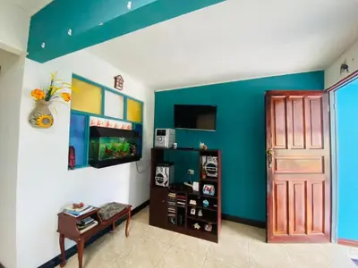 a living room with a blue and white wall at Hermosa House Tibas