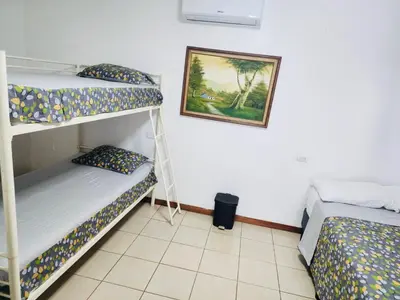a room with two bunk beds and a picture on the wall at Casa de Campo Arenal in San Francisco