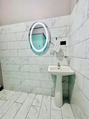 a white bathroom with a sink and a mirror at Casa de Campo Arenal in San Francisco