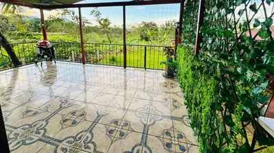 a balcony with a tile floor and a fence at Casa de Campo Arenal in San Francisco