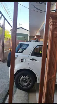 a white truck is parked in a garage at Alojamiento Vistas Chirripo espacioso con Parqueo in San Isidro