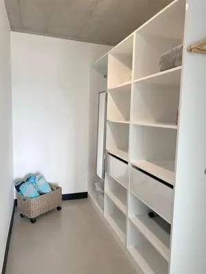 a walk in closet with white shelves in a room at Horizonte Al Este in Granadilla
