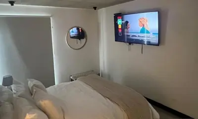 a bedroom with a bed and a flat screen tv on the wall at Horizonte Al Este in Granadilla