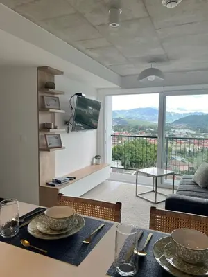 a living room with a table and a view of a living room at Horizonte Al Este in Granadilla