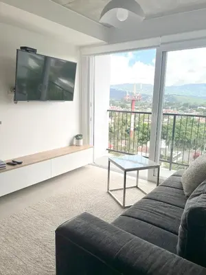 a living room with a couch and a large window at Horizonte Al Este in Granadilla