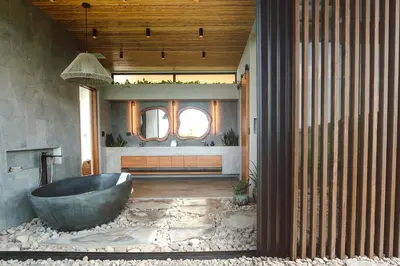 a bathroom with a large tub in the middle of a room at Casa Dominick - Luxury a short walk from the sea in Nosara