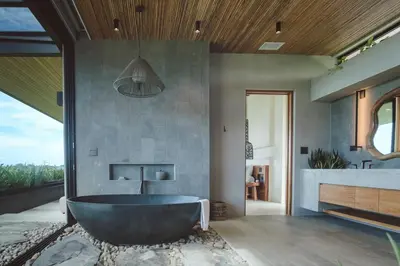 a large bathroom with a tub and a sink at Casa Dominick - Luxury a short walk from the sea in Nosara