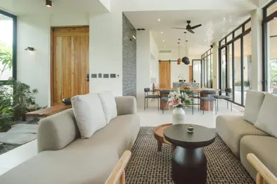 a living room with a couch and a table at Casa Dominick - Luxury a short walk from the sea in Nosara