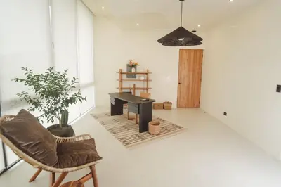 a living room with a piano and a chair at Casa Dominick - Luxury a short walk from the sea in Nosara
