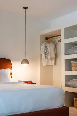 a bedroom with a bed and a closet at Villa Coro in Nosara