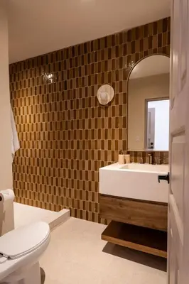 a bathroom with a sink and a toilet and a mirror at Villa Coro in Nosara