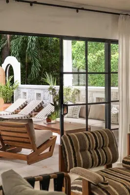 a living room with chairs and a large window at Villa Coro in Nosara