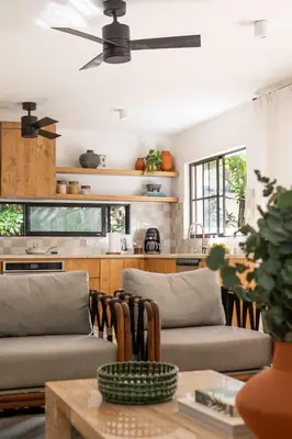 a living room with two couches and a table at Villa Coro in Nosara