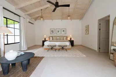 a bedroom with a bed and a ceiling fan at Villa Coro in Nosara