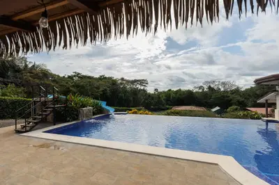 a swimming pool in a villa with a resort at Hotel Las Lomas in Nandayure
