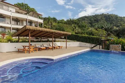 a resort with a swimming pool and a hotel at Hotel Las Lomas in Nandayure