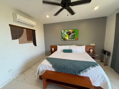 a bedroom with a bed and a ceiling fan at Hotel Las Lomas in Nandayure