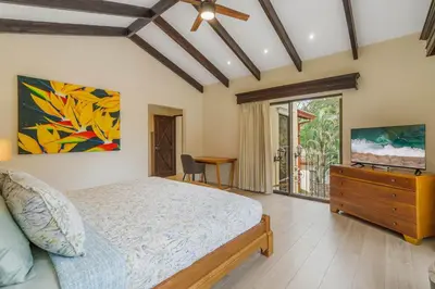 a bedroom with a bed and a dresser with a television at Elegant Surfside Retreat with Private Pool Spacious Outdoor Patio & Walkable Beach Access in Potrero