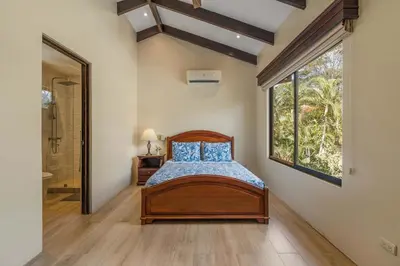 a bedroom with a bed and a large window at Elegant Surfside Retreat with Private Pool Spacious Outdoor Patio & Walkable Beach Access in Potrero