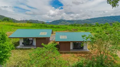 a small house with a blue roof in a field at Pejivalle Lodge paz y naturaleza en un solo lugar in Humo