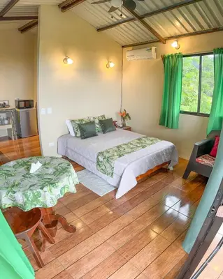 a bedroom with a bed and a table and chairs at Cabaña tranquila con vistas a la montaña y naturaleza en Monterrey in Monterrey