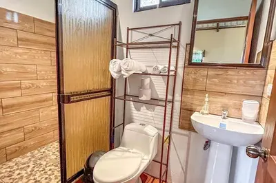 a bathroom with a toilet and a sink at Cabaña tranquila con vistas a la montaña y naturaleza en Monterrey in Monterrey