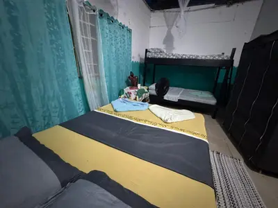 a bedroom with a bed in a room with a window at Ecobosque del Mar in Drake